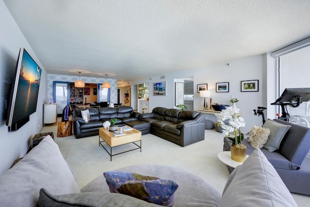 carpeted living room featuring a textured ceiling