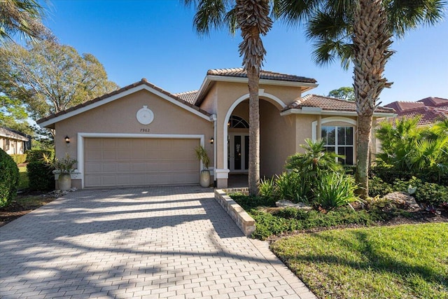 mediterranean / spanish-style home featuring a garage