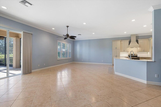 unfurnished living room featuring ornamental molding, a healthy amount of sunlight, and light tile patterned floors