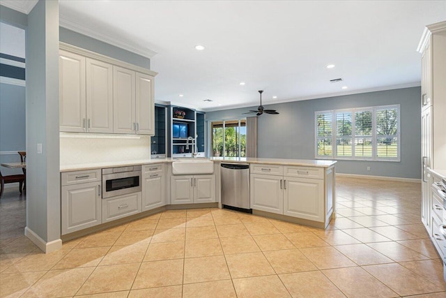 kitchen featuring sink, crown molding, light tile patterned floors, appliances with stainless steel finishes, and kitchen peninsula