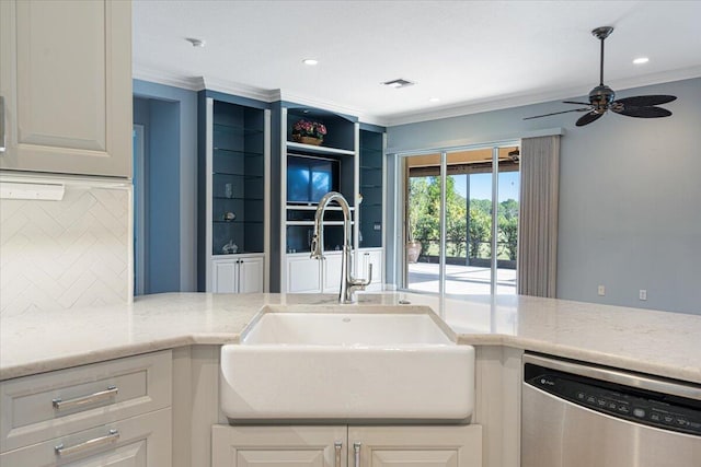 kitchen featuring sink, stainless steel dishwasher, white cabinets, and light stone countertops