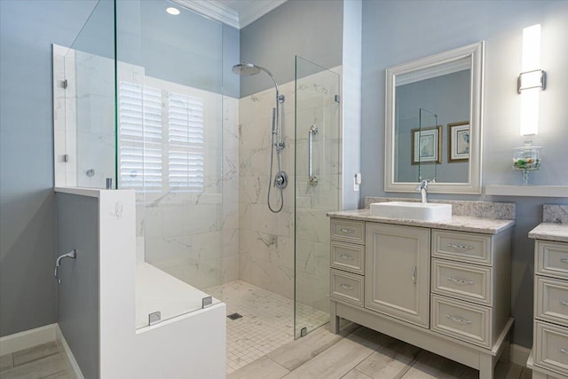 bathroom with vanity, ornamental molding, and tiled shower