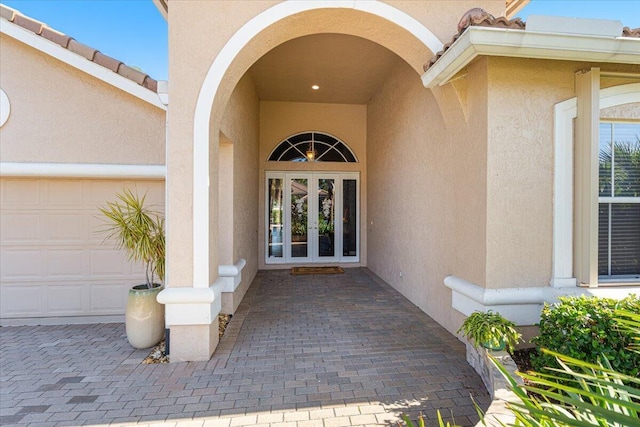 doorway to property featuring french doors and a garage