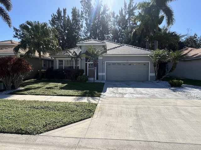 single story home featuring a front yard and a garage