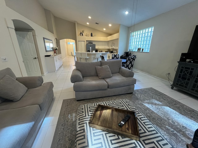 tiled living room with high vaulted ceiling