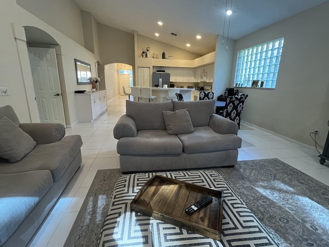 tiled living room with high vaulted ceiling