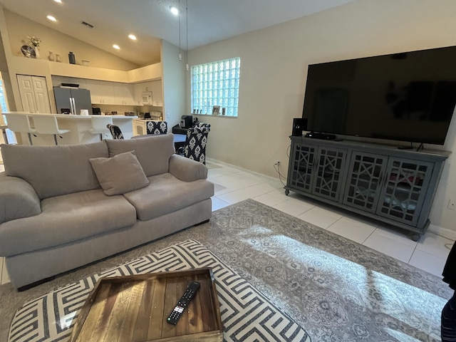 living room featuring lofted ceiling and light tile patterned floors