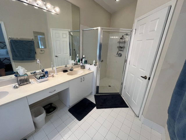 bathroom featuring vanity, tile patterned flooring, a shower with shower door, and lofted ceiling