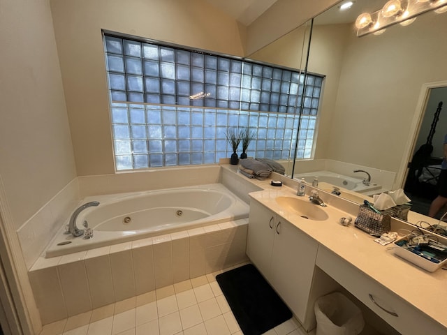 bathroom featuring vanity, a relaxing tiled tub, and tile patterned floors