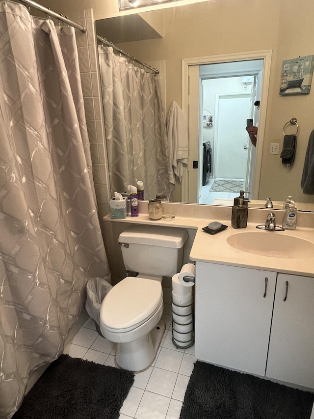 bathroom with tile patterned flooring, vanity, curtained shower, and toilet