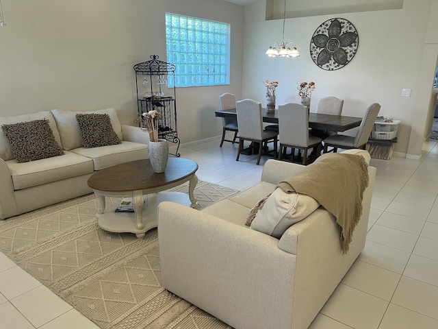 living room with a chandelier and light tile patterned floors