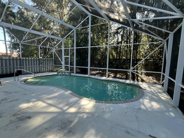 view of swimming pool with a lanai and a patio