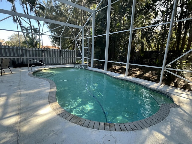 view of swimming pool with a lanai and a patio