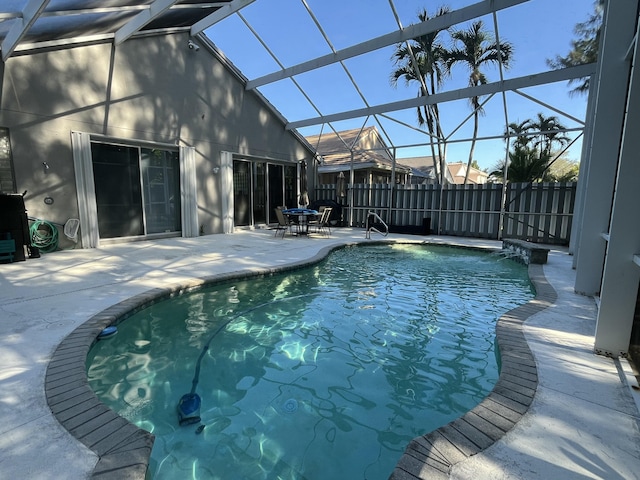 view of pool with a lanai and a patio