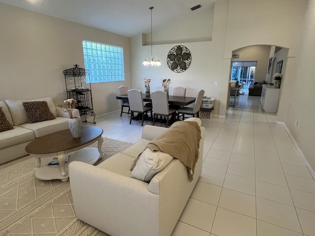 living room with light tile patterned floors and a notable chandelier