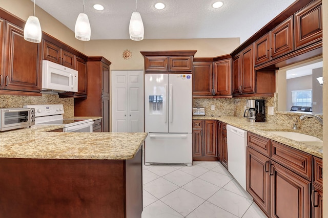 kitchen with decorative backsplash, sink, white appliances, and pendant lighting