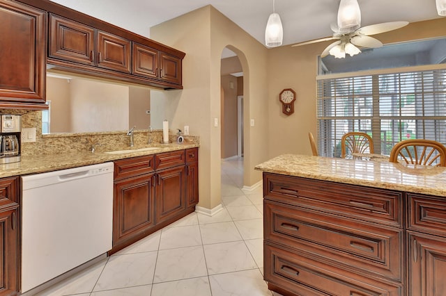 kitchen featuring white dishwasher, decorative light fixtures, light stone counters, and ceiling fan