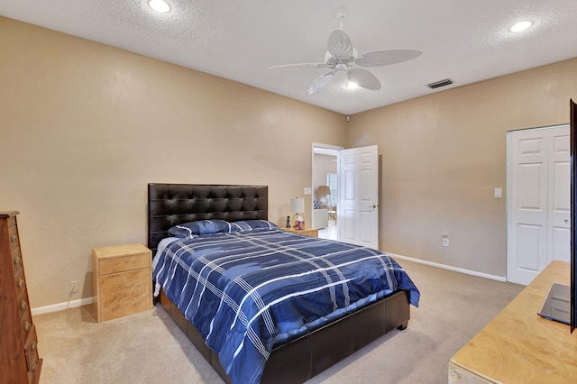 bedroom featuring ceiling fan, carpet floors, and a textured ceiling