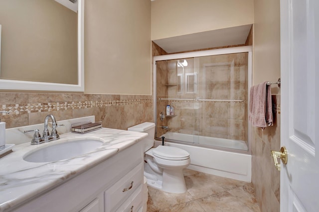 full bathroom featuring tile patterned floors, bath / shower combo with glass door, toilet, and vanity