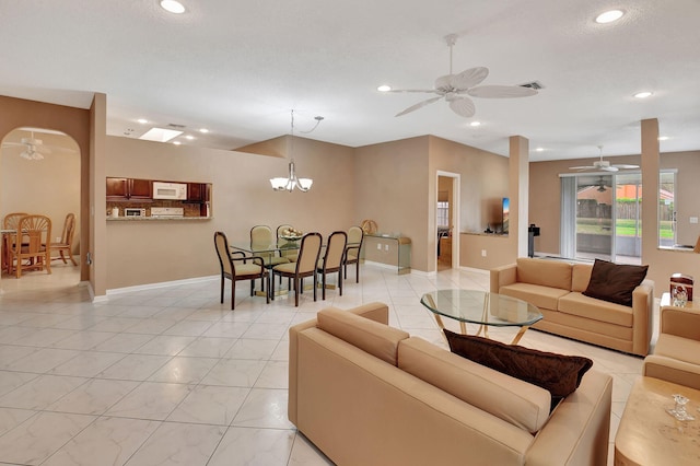 tiled living room featuring a notable chandelier