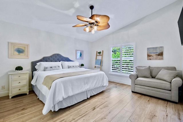 bedroom with light hardwood / wood-style flooring, ceiling fan, and lofted ceiling