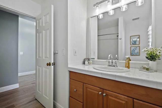 bathroom featuring vanity and hardwood / wood-style flooring