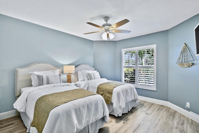 bedroom featuring ceiling fan and light hardwood / wood-style flooring