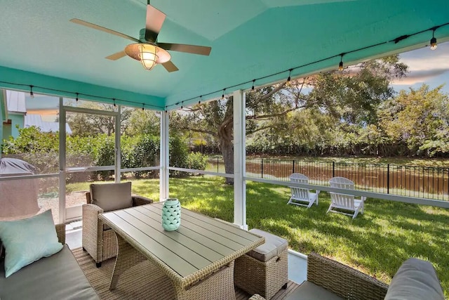 sunroom featuring ceiling fan and lofted ceiling