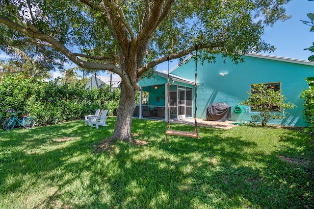 back of house featuring a sunroom and a yard