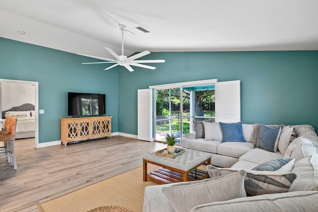 living room featuring ceiling fan, light wood-type flooring, and lofted ceiling