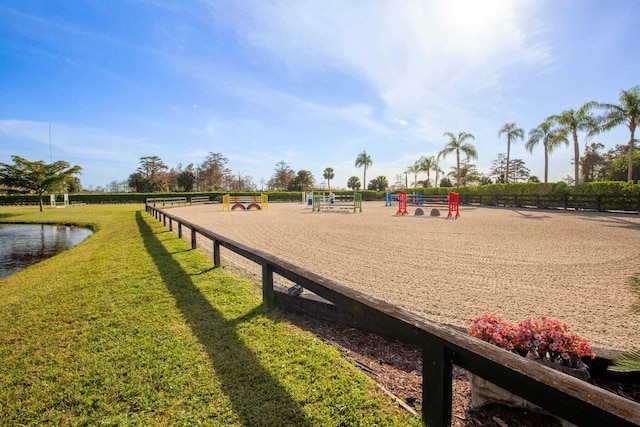 view of playground with a water view and a lawn