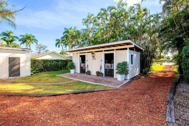 view of outbuilding with a lawn