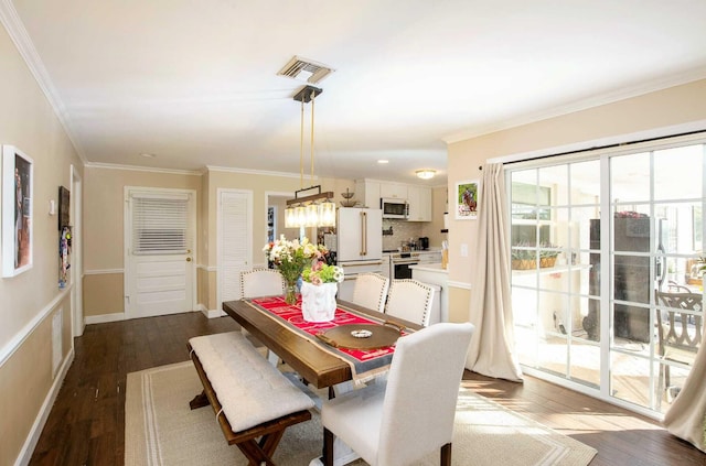 dining space with dark hardwood / wood-style floors and ornamental molding