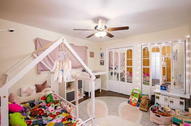 playroom with ceiling fan and wood-type flooring