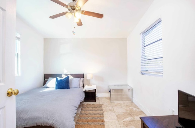 bedroom with ceiling fan and light tile patterned flooring