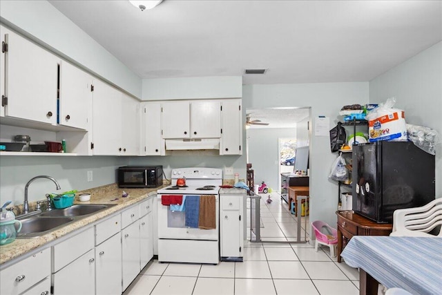 kitchen featuring ceiling fan, sink, light tile patterned floors, white range with electric cooktop, and white cabinets