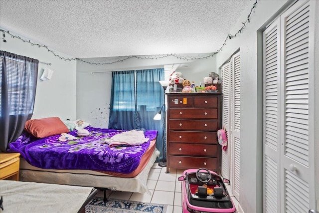 tiled bedroom with a textured ceiling