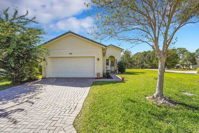 view of front of property featuring a garage and a front lawn