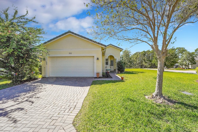 view of front of home with decorative driveway, a front yard, an attached garage, and stucco siding