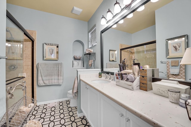 full bath with a stall shower, vanity, toilet, and baseboards