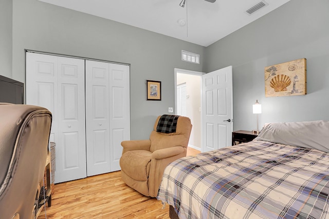 bedroom with a closet, visible vents, ceiling fan, and light wood-style flooring