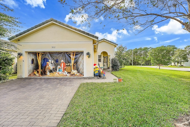 view of front of house featuring a front yard and a garage