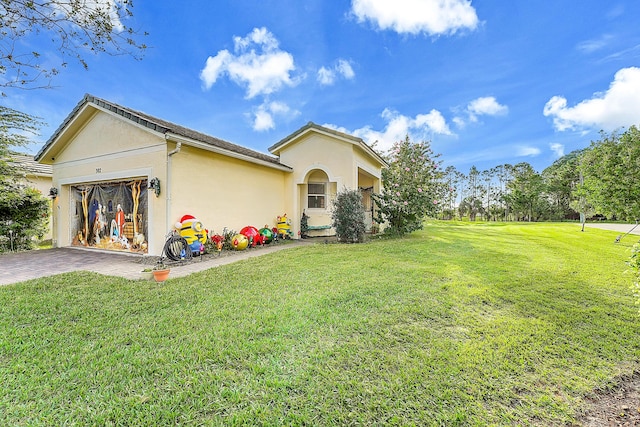 exterior space with a lawn and a garage