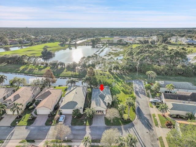 drone / aerial view with a water view and a residential view