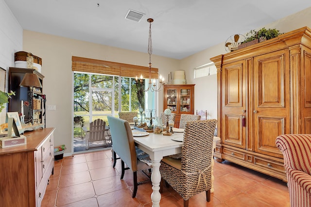 dining area featuring a chandelier, visible vents, and light tile patterned flooring