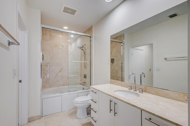 full bathroom featuring tile patterned floors, vanity, bath / shower combo with glass door, and toilet