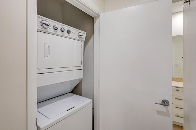 washroom featuring stacked washing maching and dryer