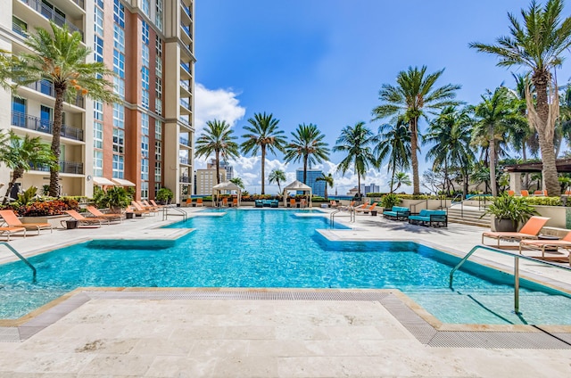 view of pool with pool water feature and a patio