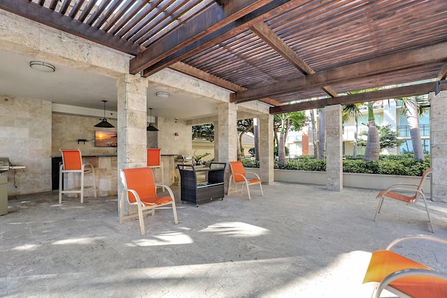 view of patio with a bar and a pergola