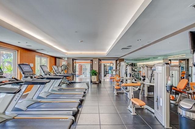 workout area featuring a tray ceiling